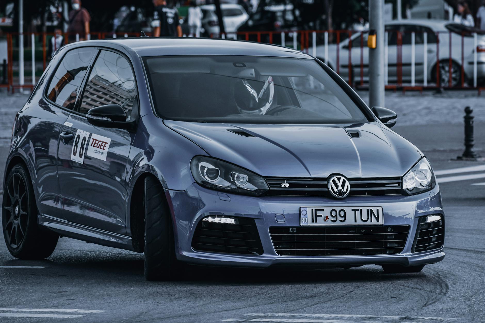 Sportowy Volkswagen pokonuje zakręt na miejskim torze wyścigowym