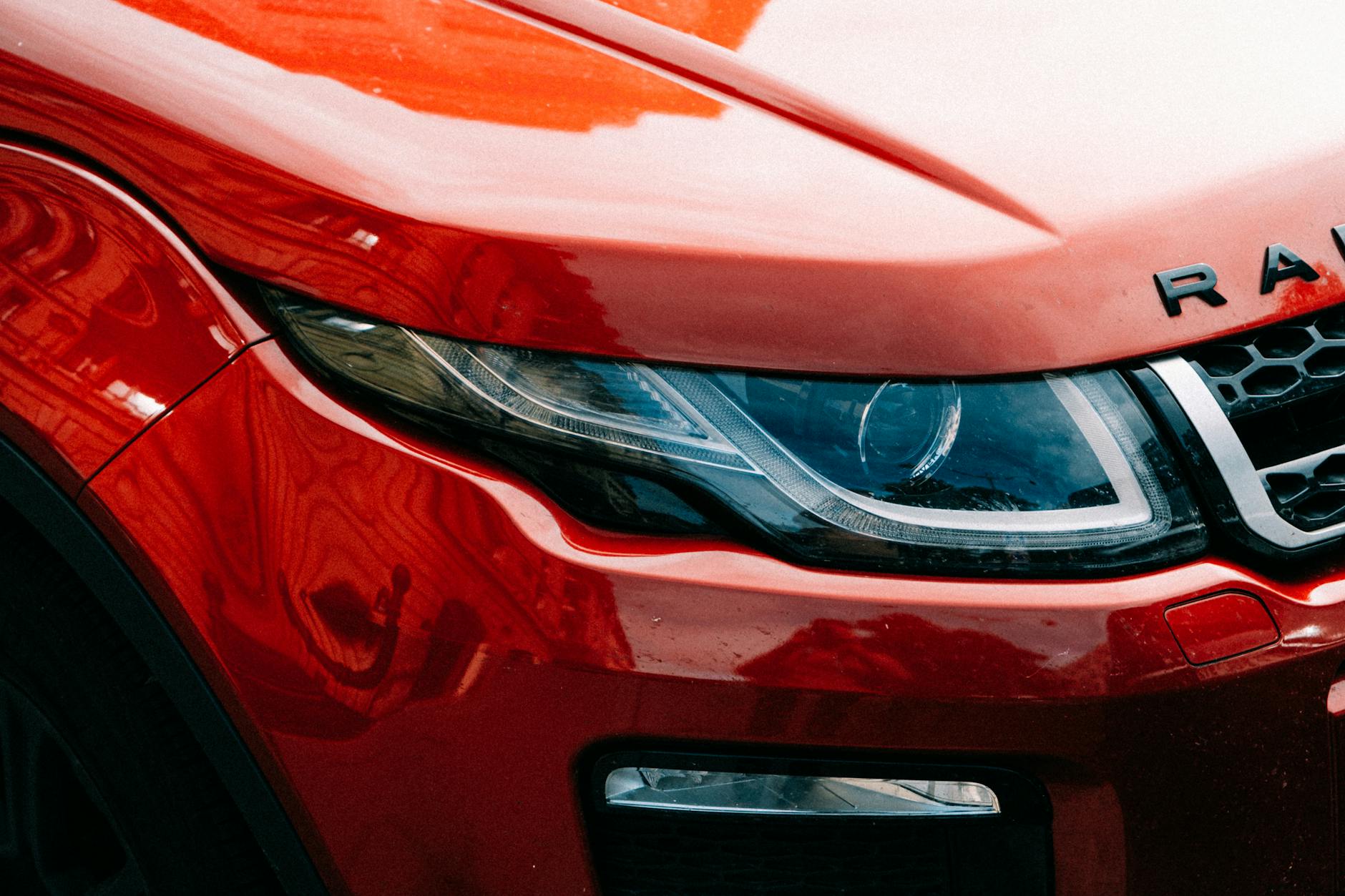 Zbliżenie na reflektor czerwonego SUV-a Ferrari Purosangue
